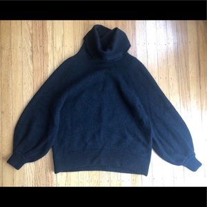 Relaxed turtleneck wool sweater with bell sleeves